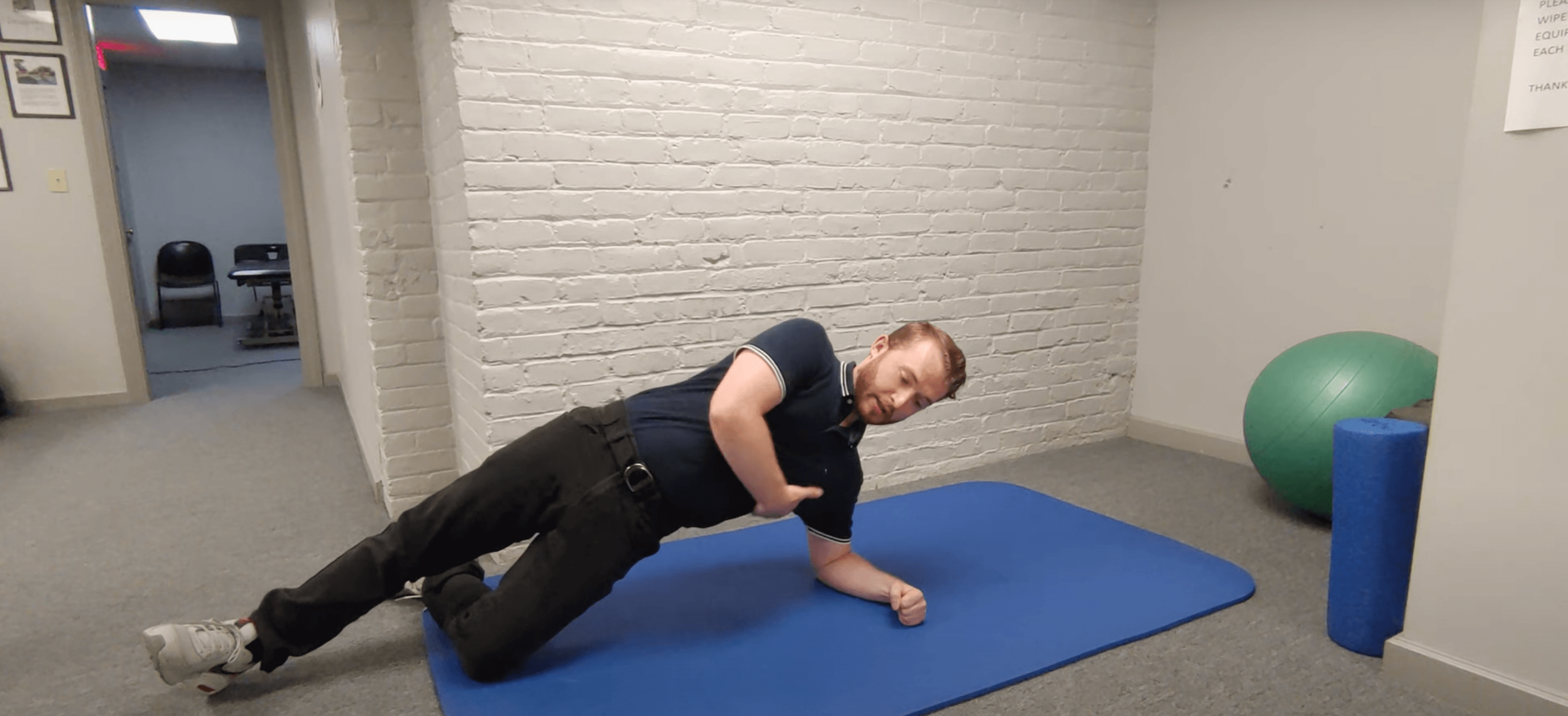 man doing side plank exercise